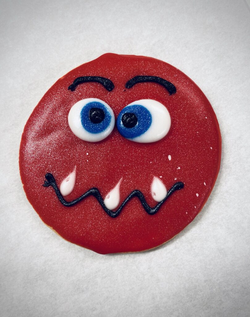 Red treat with eyes, eyebrows and wavy mouth