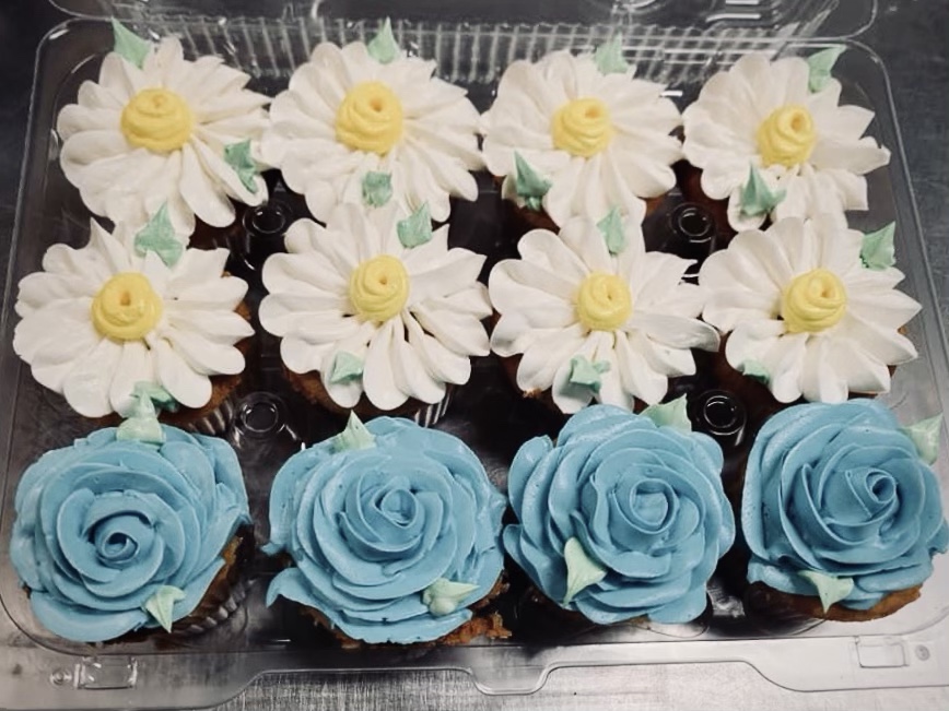cupcakes with white and blue flower frosting