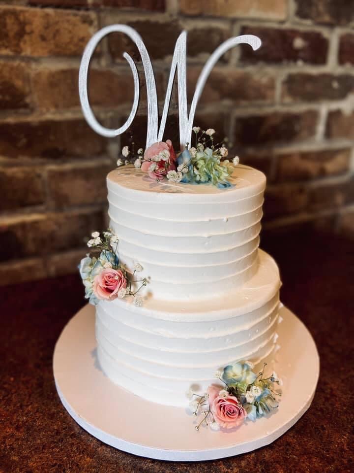 Two layer cake with flower design and W cake topper