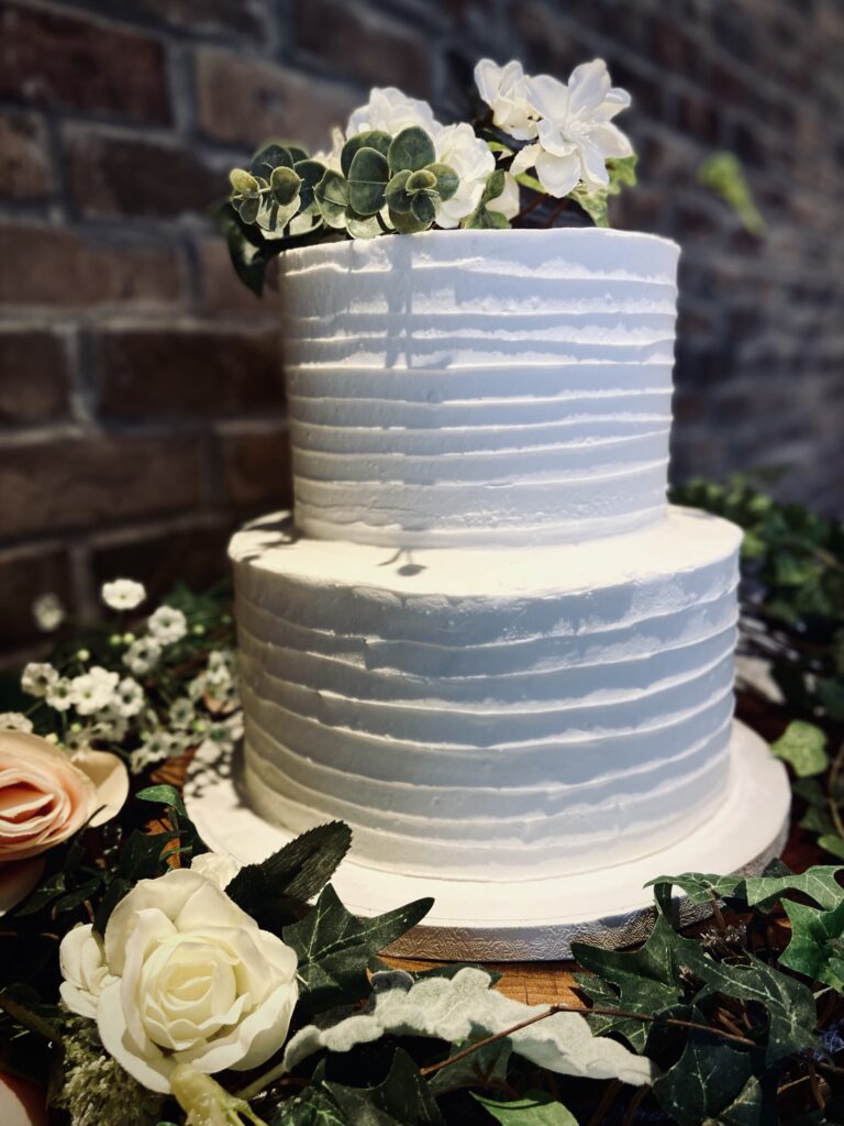Two layer cake with flowers at the top
