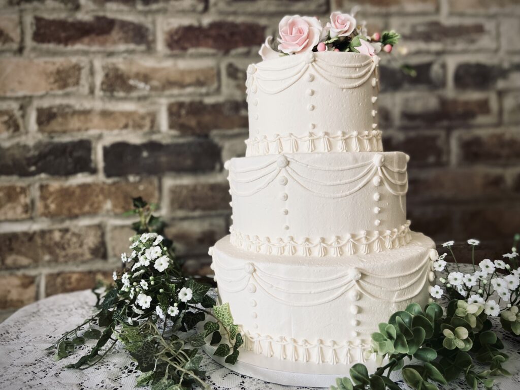 Three layer cake with flower design at the top
